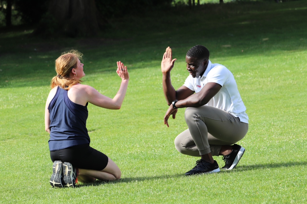 personal trainer doing high five with client