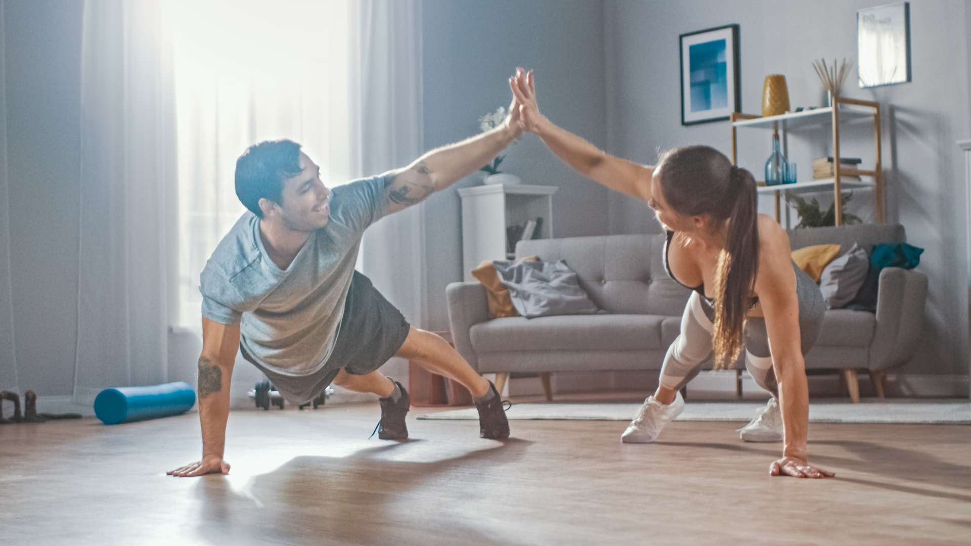 woman and man doing squats from home